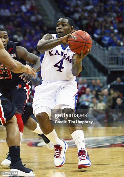 Sherron Collins of the Kansas Jayhawks passes the ball against the Texas Tech Red Raiders during the quarterfinals of the 2010 Phillips 66 Big 12...