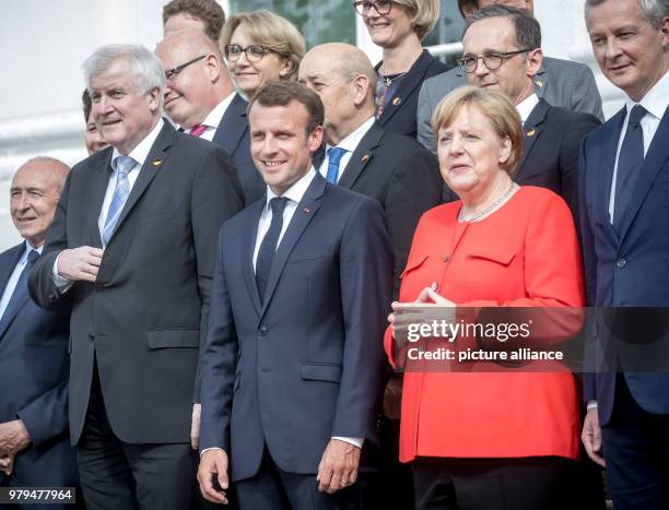 June 2018, Germany, Meseberg: German Chancellor Angela Merkel of the Christian Democratic Union stands next to President of France, Emmanuel Macron,...