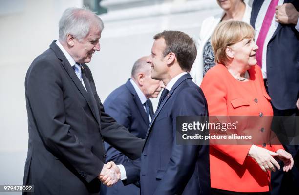 June 2018, Germany, Meseberg: President of France, Emmanuel Macron, greets Horst Seehofer of the Christian Social Union , German Minister of the...