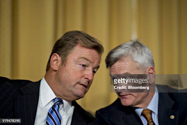 Senator Dean Heller, a Republican from Nevada, left, talks to Senator Bill Cassidy, a Republican from Louisiana, during a Senate Finance Committee...