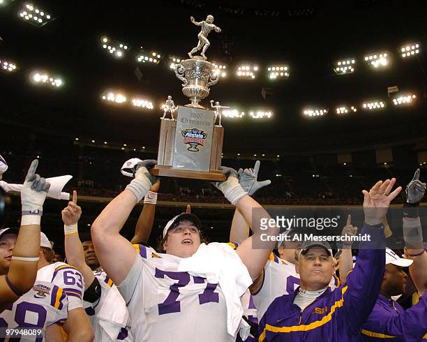 Coach Les Miles and offensive tackle Peter Dyakowski with the championship trophy after a win against Notre Dame in the Allstate Sugar Bowl at the...