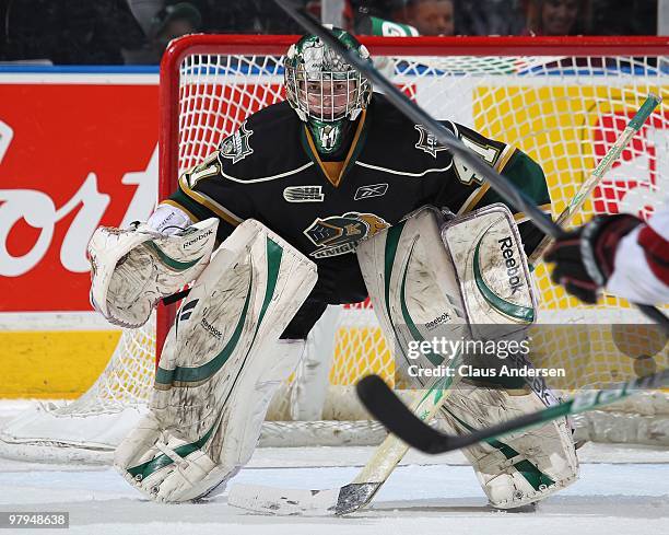 Michael Hutchinson of the London Knights keeps an eye on the play in the first game of the opening round of the 2010 playoffs against the Guelph...