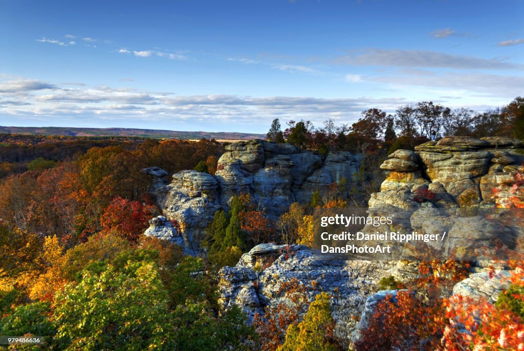 Rock formations surrounded by trees with autumnal foliage on sunny day, Illinois, USA