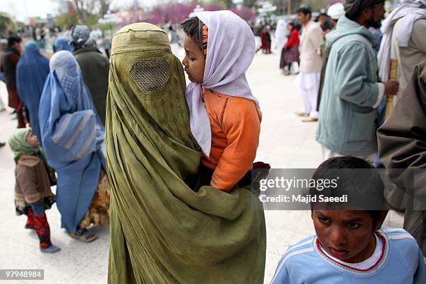 Burqa-clad Afghan woman passes the outside of the Hazrat-i Ali shrine in Mazar-i-Sharif, the centre of Afghan New Year's or Nauruz celebrations, on...