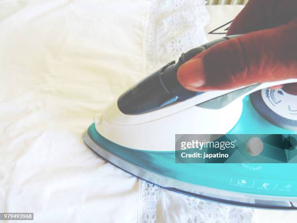 homework. ironing of clothes on ironing board - pantalón decorado fotografías e imágenes de stock