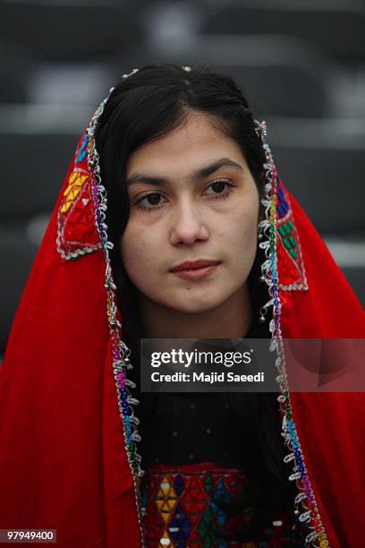 An Afghan woman looks on during a ceremony on the solar-based New Year's or Nowruz, on March 22, 2010 in Mazar-i-Sharif, the capital of ancient Balkh...