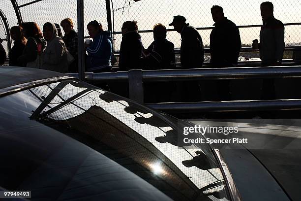 People wait in line at the border to get into the Uniteds States from Mexico March 21, 2010 in Juarez, Mexico. The border city of Juarez has suffered...