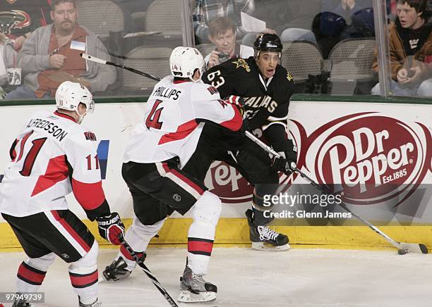 Mike Ribeiro of the Dallas Stars looks to pass to a teammate against Chris Phillips and Daniel Alfredsson of the Ottawa Senators on March 20, 2010 at...