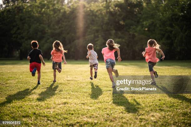 back view group of children running in nature - playing stock pictures, royalty-free photos & images
