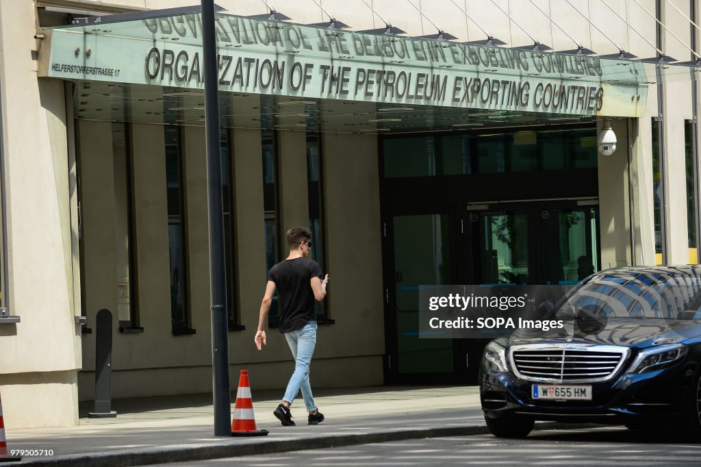 People pass by OPEC logo at the  Organisation of Petroleum...