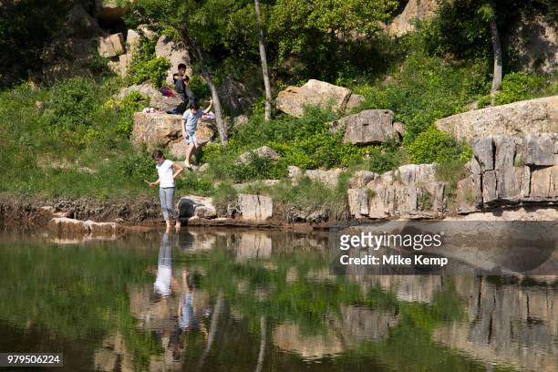 Kids playing along the river in the medieval village of Lagrasse, Languedoc-Roussillon, France. Lagrasse is known as one of the most beautiful French...