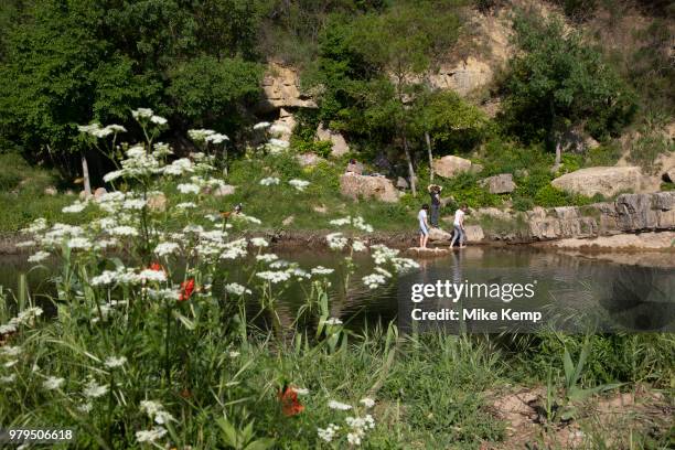 Kids playing along the river in the medieval village of Lagrasse, Languedoc-Roussillon, France. Lagrasse is known as one of the most beautiful French...