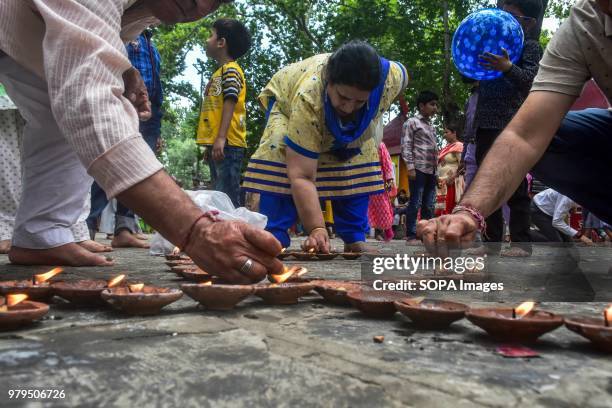 Hindu devotees light oil lamps during the annual Hindu festival at the Kheer Bhawani Temple in Ganderbal district, some 30kms northeast of Srinagar,...