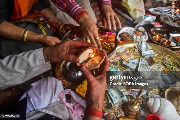 Hindu devotee lights an oil lamp as he prays inside the Kheer Bhawani Temple during the annual Hindu festival in Ganderbal district, some 30kms...