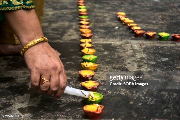 Hindu woman lights oil lamps during the annual Hindu festival at the Kheer Bhawani Temple in Ganderbal district, some 30kms northeast of Srinagar,...
