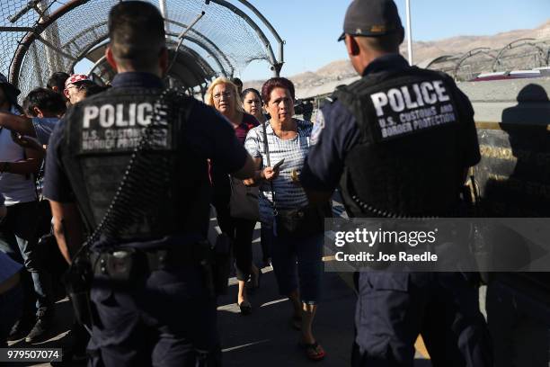 Border Patrol agents check passports at the Paso Del Norte Port of Entry, where the U.S. And Mexico border meet, as people walk across the bridge to...