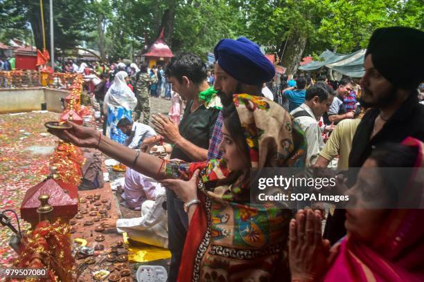 Hindu Devotees pray during the annual Hindu festival at the Kheer Bhawani Temple in Ganderbal district, some 30kms northeast of Srinagar, Indian...