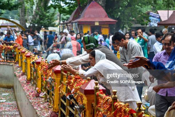 Hindu devotees perform rituals at the Kheer Bhawani temple during an annual Hindu festival in Ganderbal district, some 30kms northeast of Srinagar,...