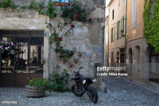 Scene in the medieval village of Lagrasse, Languedoc-Roussillon, France. Lagrasse is known as one of the most beautiful French villages. It lies in...