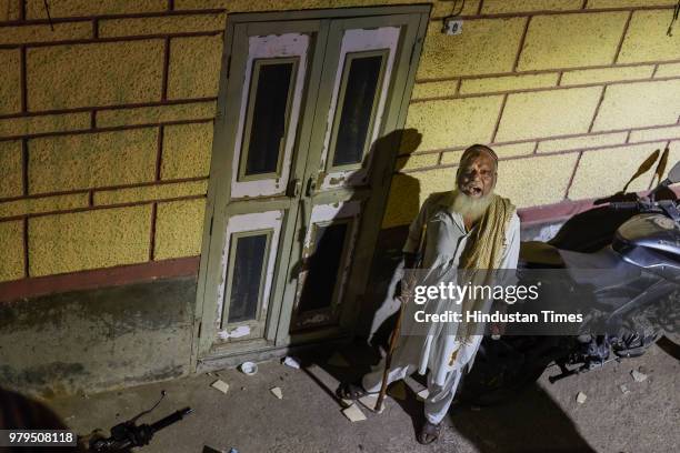 Wearing a white pathani suit, skull cap and a keffiyeh spread across his left shoulder, Nawabuddin or Peer ji, limps to each structure, carrying a...