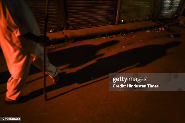 Wearing a white pathani suit, skull cap and a keffiyeh spread across his left shoulder, Nawabuddin or Peer ji, limps to each structure, carrying a...