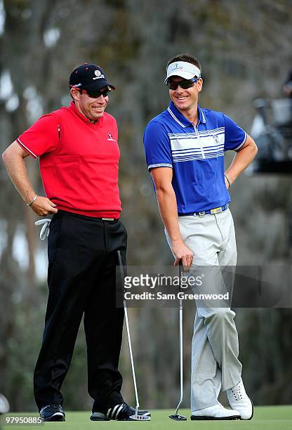 Brian Davis of England and Henrik Stenson of Sweden talk during the first day's play in the 2010 Tavistock Cup at Isleworth Golf and Country Club on...