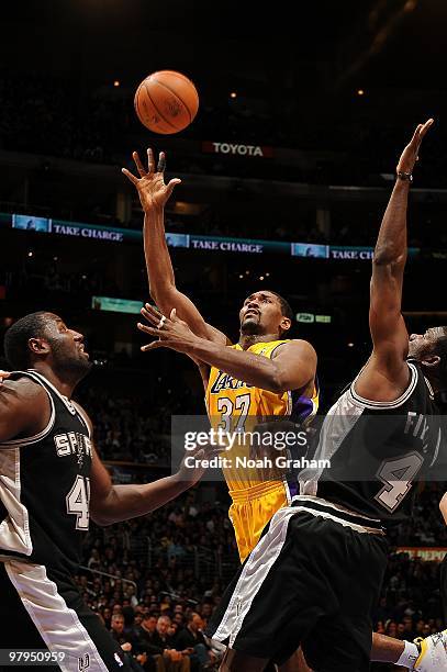 Ron Artest of the Los Angeles Lakers puts up a shot against DeJuan Blair and Michael Finley of the San Antonio Spurs during the game on February 8,...