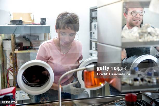 researchers working in organic semiconductors research laboratory - glove box stock pictures, royalty-free photos & images