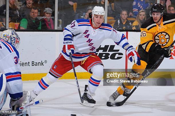 Brandon Dubinsky of the New York Rangers skates with the puck against David Krejci of the Boston Bruins at the TD Garden on March 21, 2010 in Boston,...
