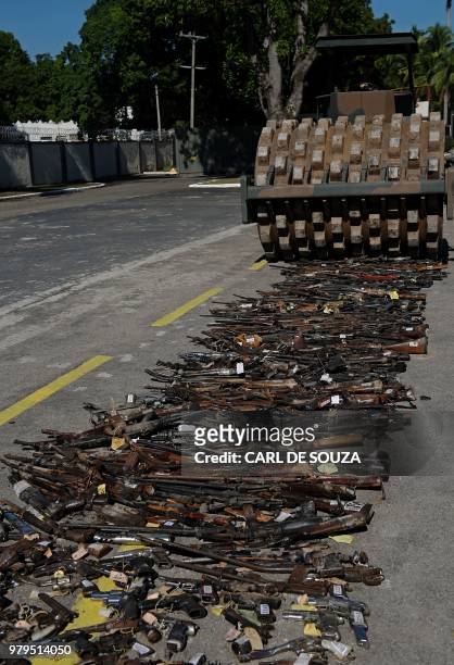 Guns seized from criminals by Brazilian armed forces are crushed and destroyed at a military base in Rio de Janeiro, Brazil, on June 20, 2018. - The...