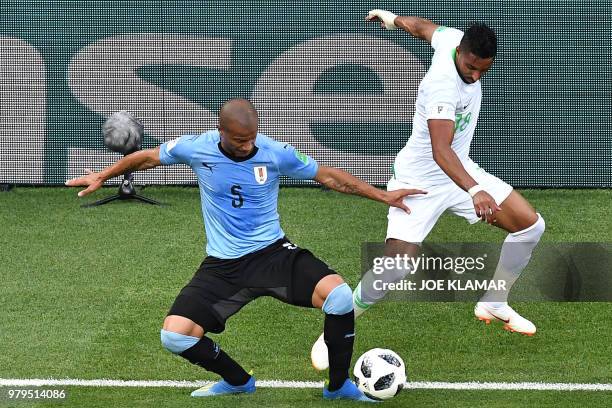 Uruguay's midfielder Carlos Sanchez vies with Saudi Arabia's forward Salem Al-Dawsari during the Russia 2018 World Cup Group A football match between...