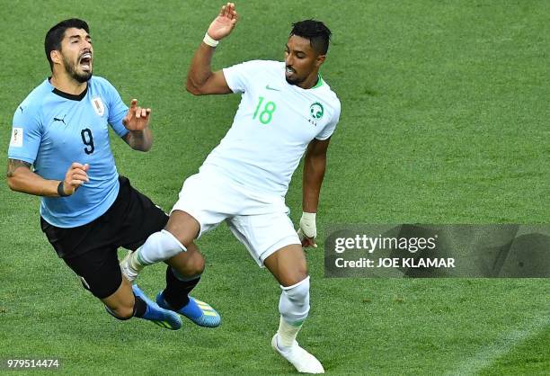 Uruguay's forward Luis Suarez fights for the ball with Saudi Arabia's forward Salem Al-Dawsari during the Russia 2018 World Cup Group A football...