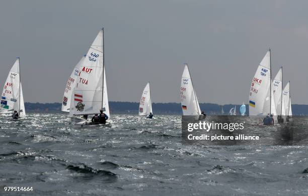 June 2018, Germany, Kiel: Sailers in the 470 class participate in a race on the Schilksee as part of the Kiel Week. The Kiel Week is the world's...