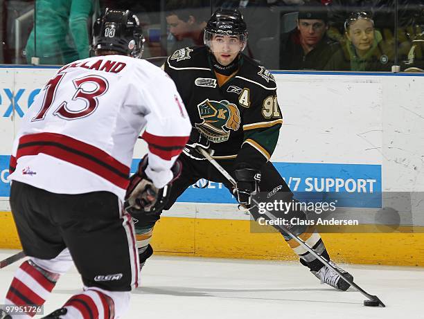 Nazem Kadri of the London Knights tries to elude the check of Peter Holland of the Guelph Storm in the first game of the opening round of the 2010...