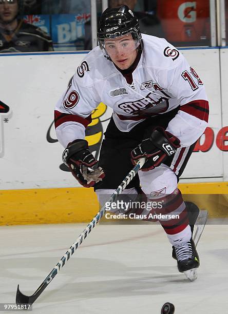 Taylor Beck of the Guelph Storm skates after a loose puck in the first game of the opening round of the 2010 playoffs against the London Knights on...