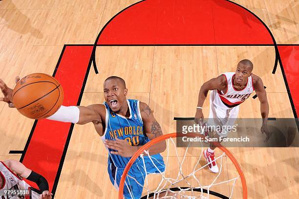 David West of the New Orleans Hornets grabs a rebound over Dante Cunningham of the Portland Trail Blazers during the game on January 25, 2010 at the...