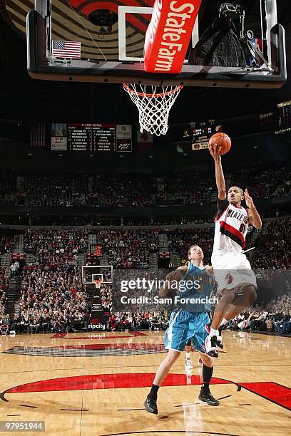 Nicolas Batum of the Portland Trail Blazers lays the ball up over Darius Songaila of the New Orleans Hornets during the game on January 25, 2010 at...