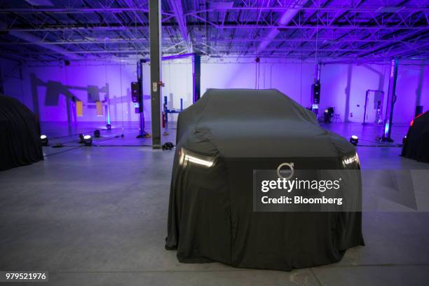 Cover conceals the Volvo S60 vehicle before an unveiling event at the official opening of the Volvo Cars USA plant in Ridgeville, South Carolina,...