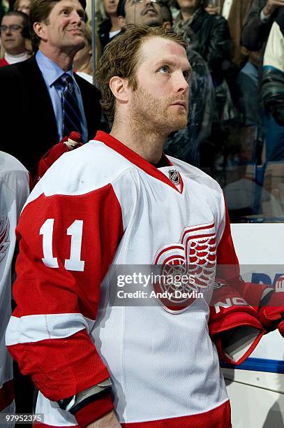 Daniel Cleary of the Detroit Red Wings stands for the national anthems before a game against the Edmonton Oilers at Rexall Place on March 19, 2010 in...