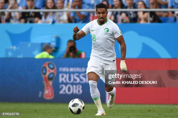 Saudi Arabia's forward Salem Al-Dawsari runs with the ball during the Russia 2018 World Cup Group A football match between Uruguay and Saudi Arabia...