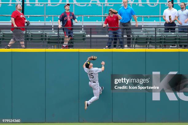 Chicago White Sox center fielder Adam Engel scales the wall in a failed attempt to catch the 3-run home run ball hit by Cleveland Indians third...