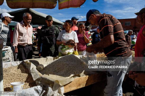 Member of the national guard walks around the municipal market of Coche, a neighbourhood of Caracas, during an inspection to control prices, on June...