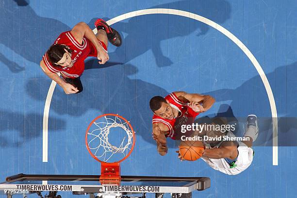 Ryan Gomes of the Minnesota Timberwolves shoots a layup against Jared Jeffries of the Houston Rockets during the game at Target Center on March 06,...