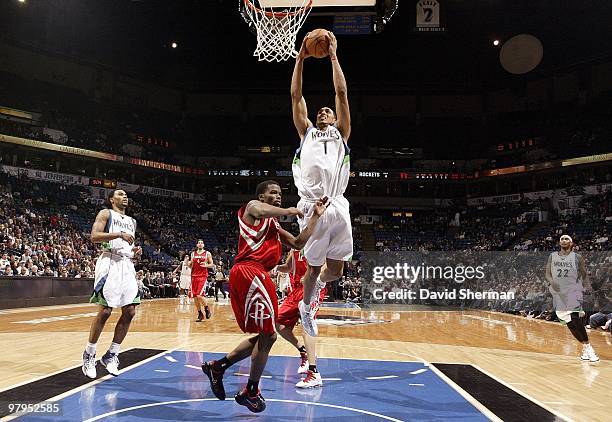 Ryan Hollins of the Minnesota Timberwolves takes the ball to the basket over Aaron Brooks of the Houston Rockets during the game at Target Center on...