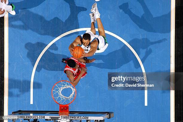 Ryan Hollins of the Minnesota Timberwolves takes the ball to the basket over Aaron Brooks of the Houston Rockets during the game at Target Center on...