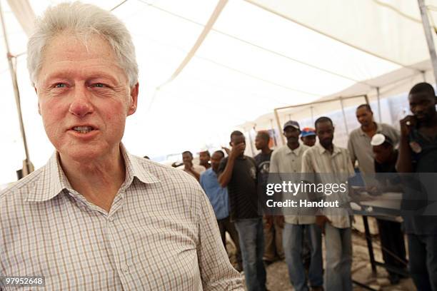 In this handout image provided by the United Nations Stabilization Mission in Haiti , former U.S. President Bill Clinton speaks to the workers at the...