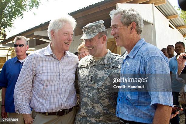 In this handout image provided by the United Nations Stabilization Mission in Haiti , Former U.S. Presidents, William Jefferson Clinton and George W....