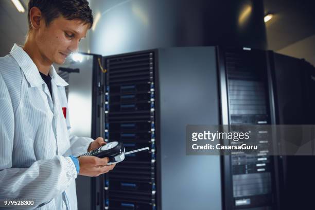 young it technician printing out sticker for network server labeling - labeling stock pictures, royalty-free photos & images