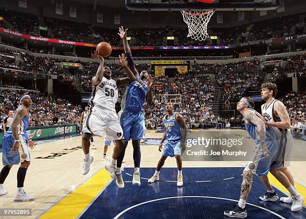 Zach Randolph of the Memphis Grizzlies goes up for a shot against Johan Petro of the Denver Nuggets during the game at the FedExForum on March 13,...