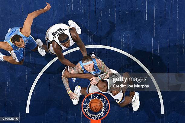 Zach Randolph and Hasheem Thabeet of the Memphis Grizzlies along with Chris Andersen and Malik Allen of the Denver Nuggets eye the ball as it goes in...